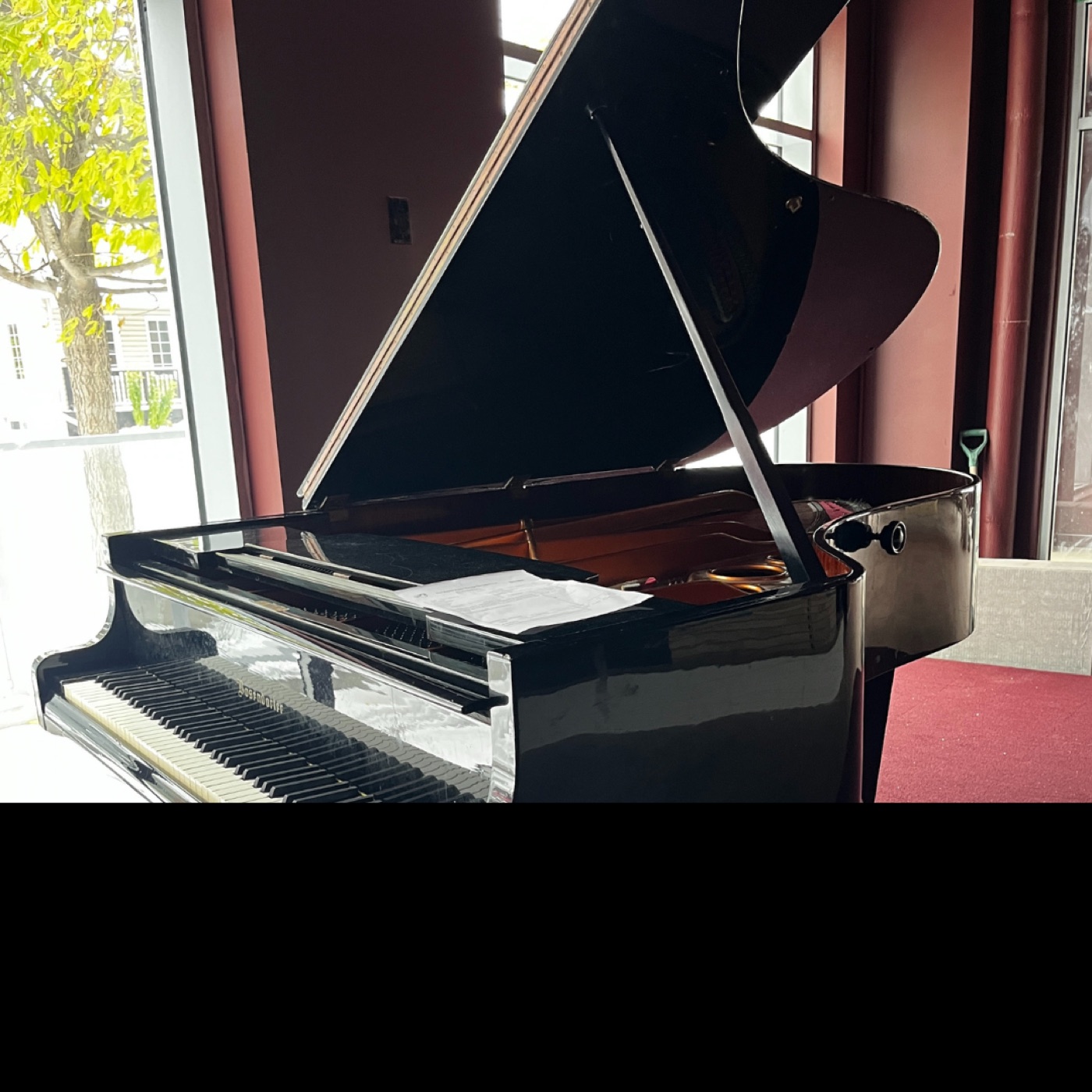 The grand piano beside the lounge windows.