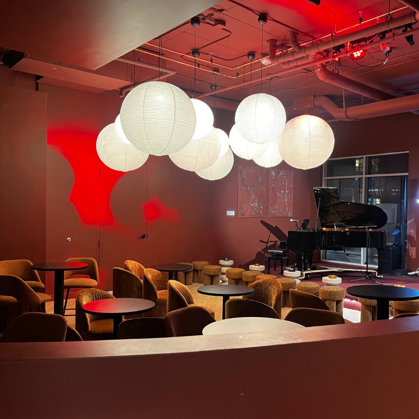 The deep-red Robo Lounge with paper lanterns, velvet chairs and a grand piano.