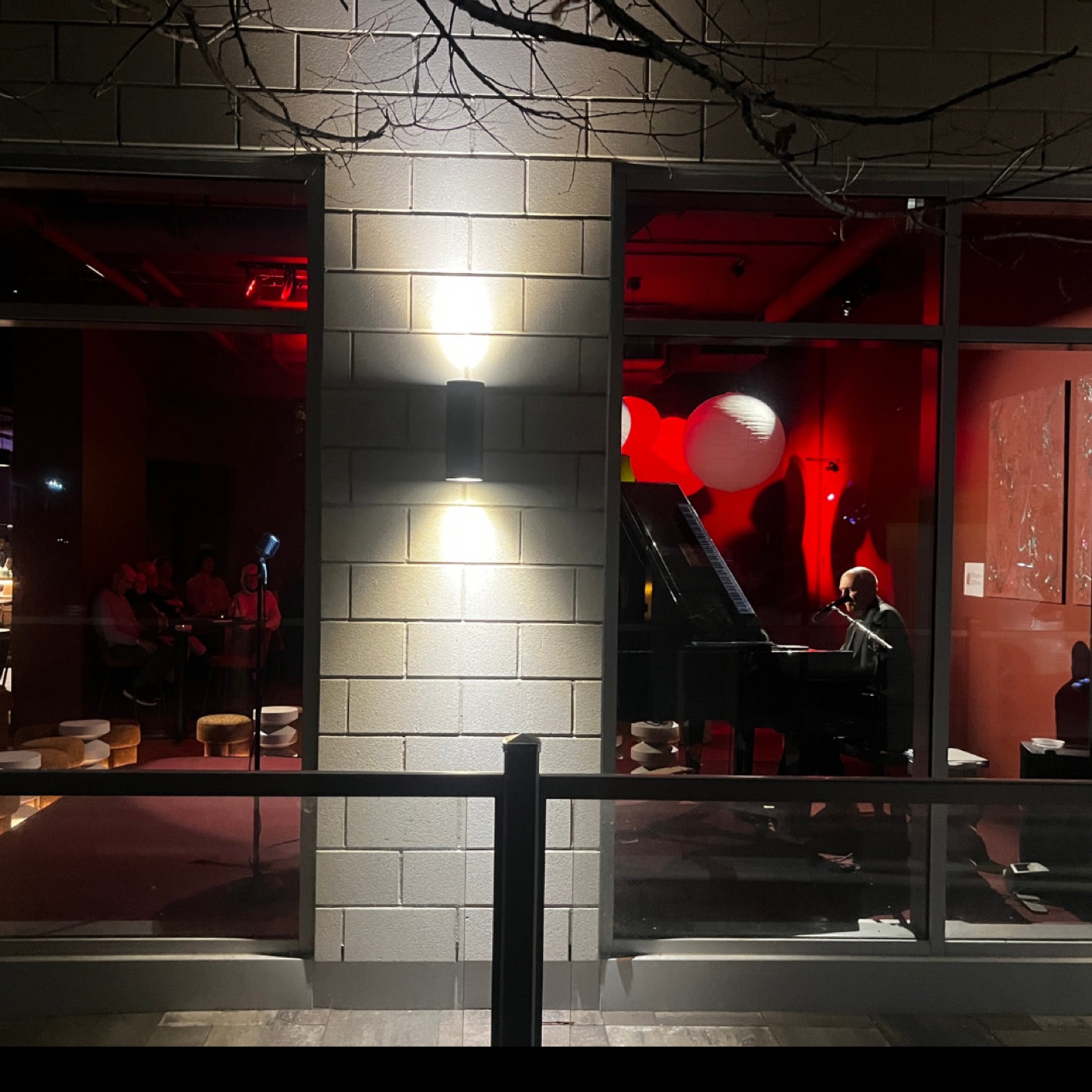 The Cambridge Street entrance glowing red after dark.